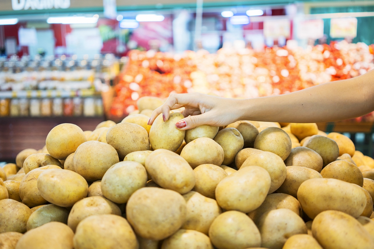 Hands grabbing potatoes